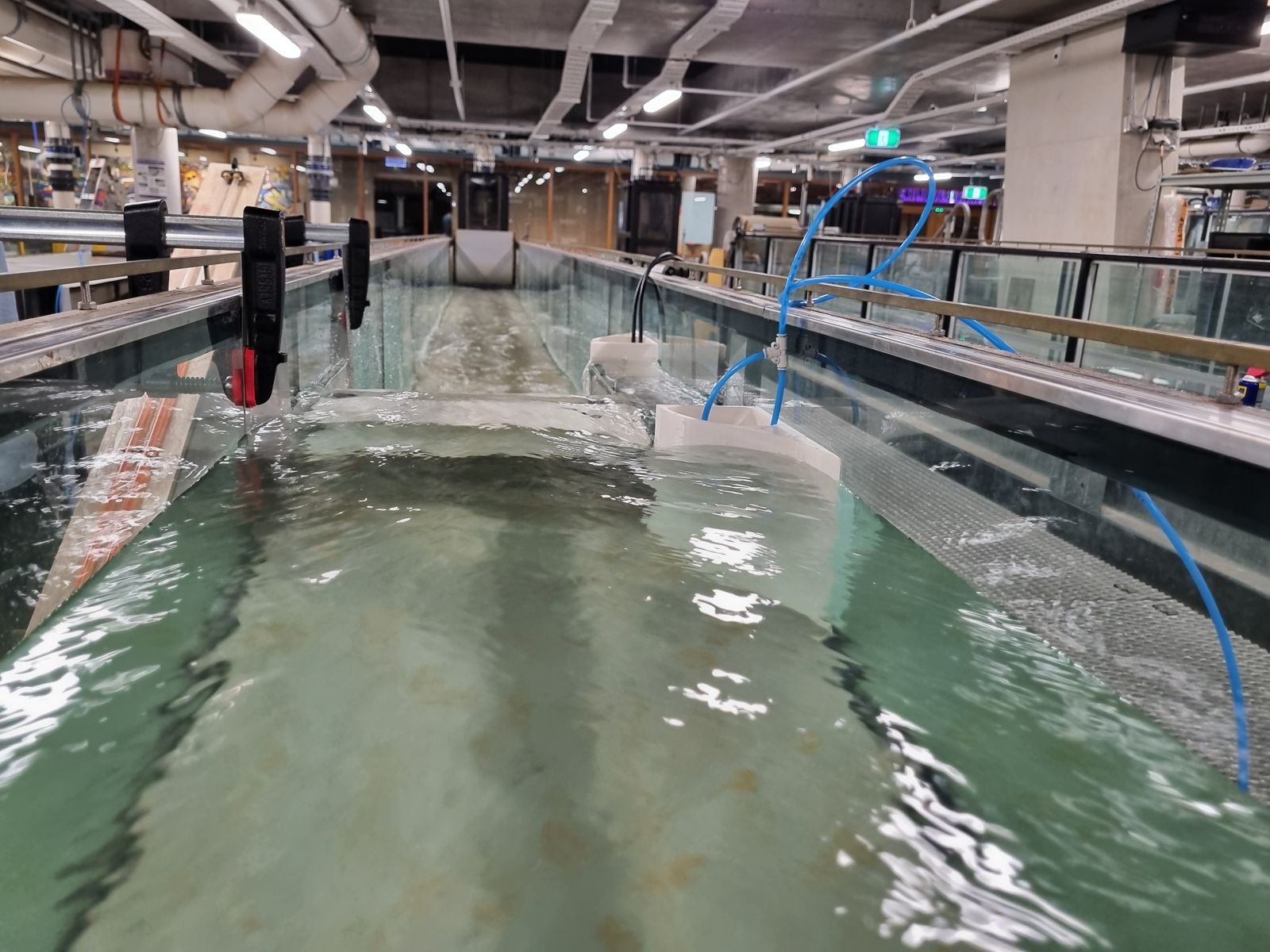 Looking down the laboratory flume with water flowing during testing